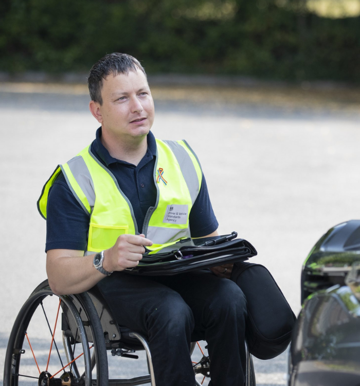 Nick Kimber, DVSA driving examiner, sitting in a wheelchair.