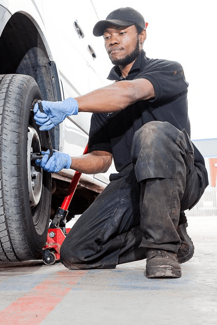 Man changing the tyre of a large vehicle