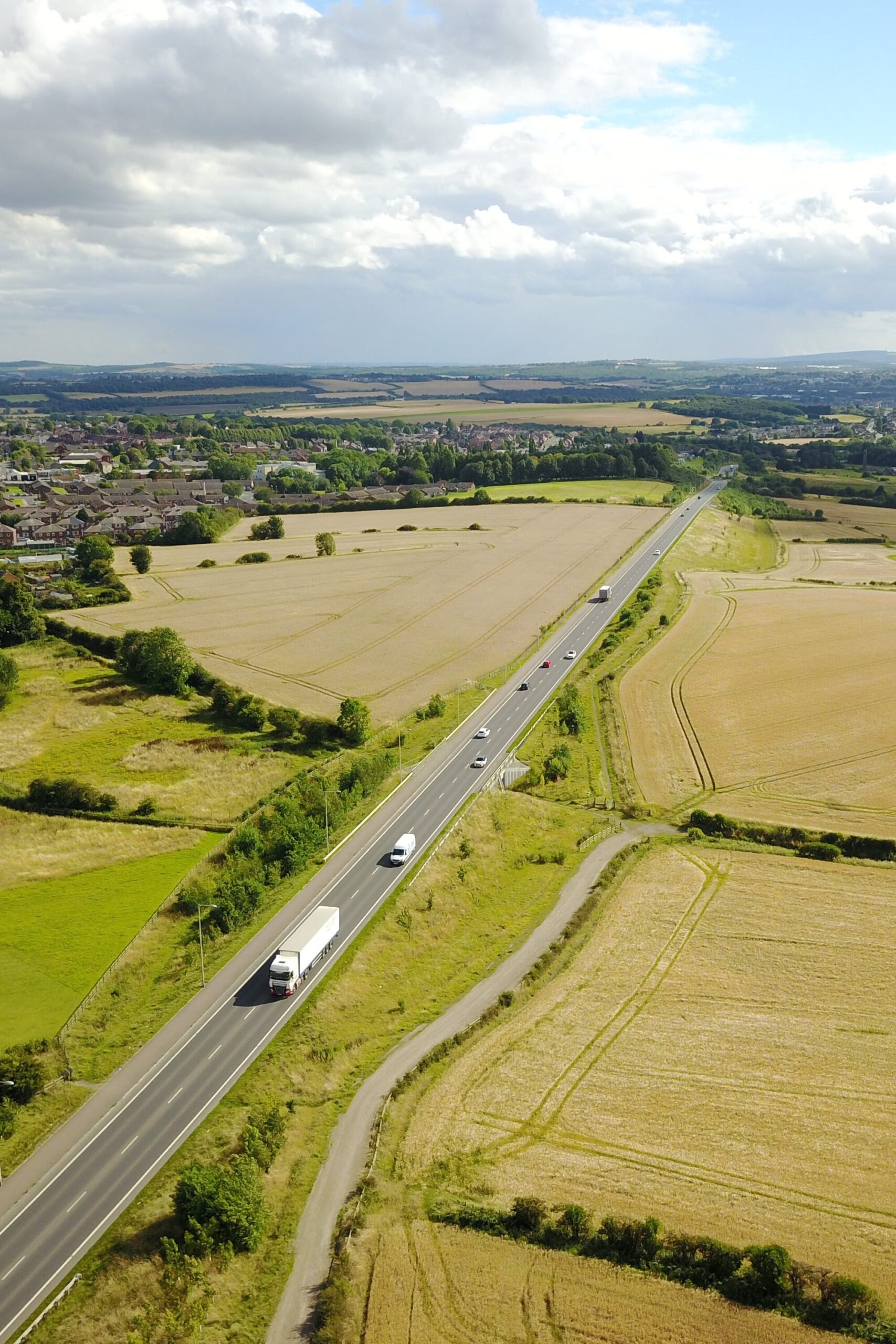 A long road of vehicles travelling through the green countryside. DVSA developed an online tool for haulage and PCV companies to apply for and maintain their Vehicle Operator Licence.